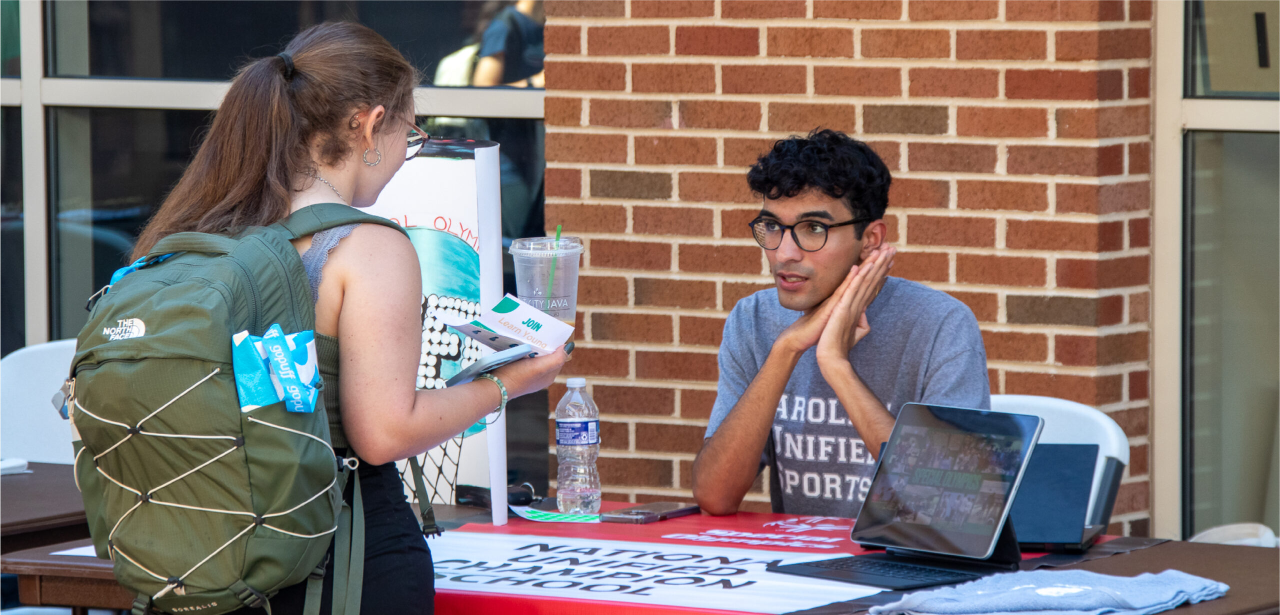 A student organization rep speaks with a student at SmallFest.