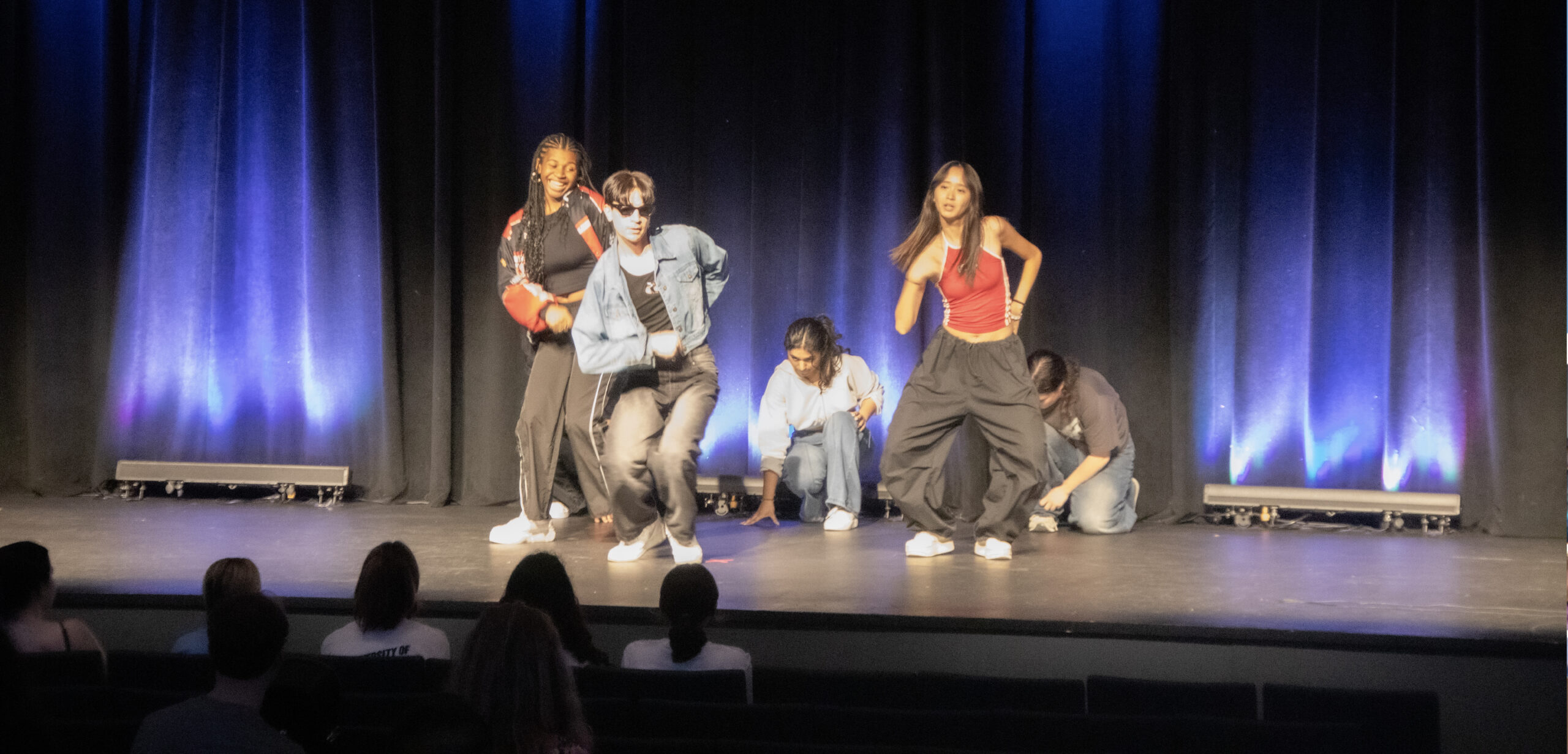 A student org dance performance at FallFest on stage in the Union auditorium.