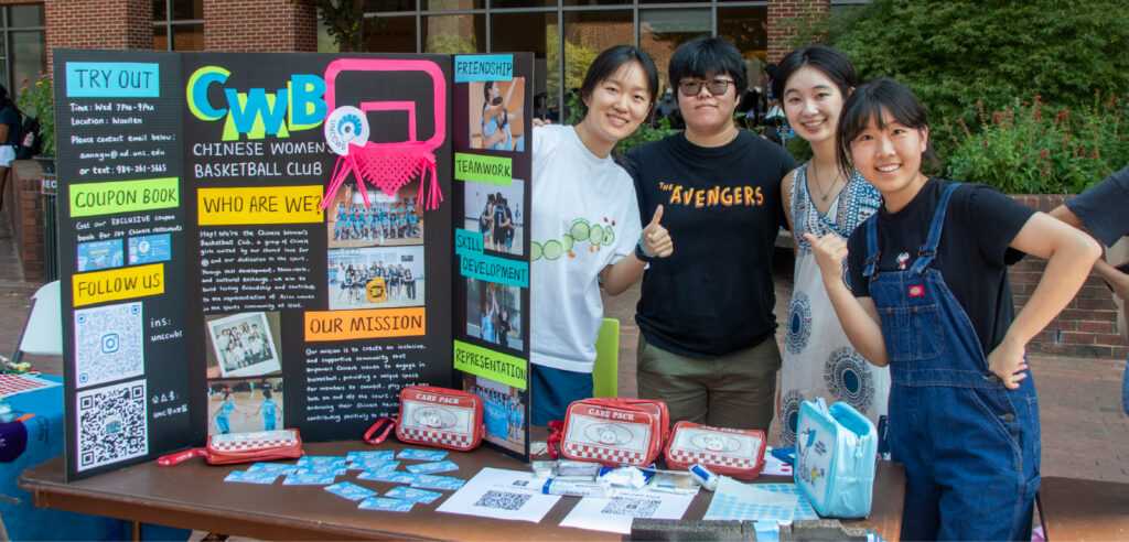 Students from the Chinese Women's Basketball Club pose with their organization's poster at S.O.L.E. Fest.